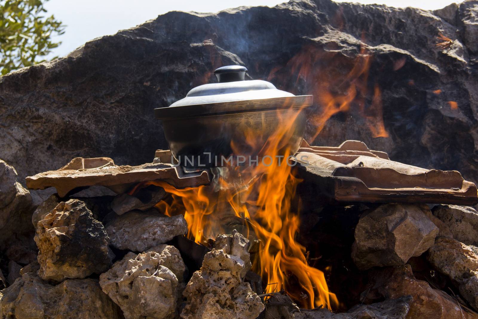 pot of fish soup being prepared on the fire, a warm quiet evening