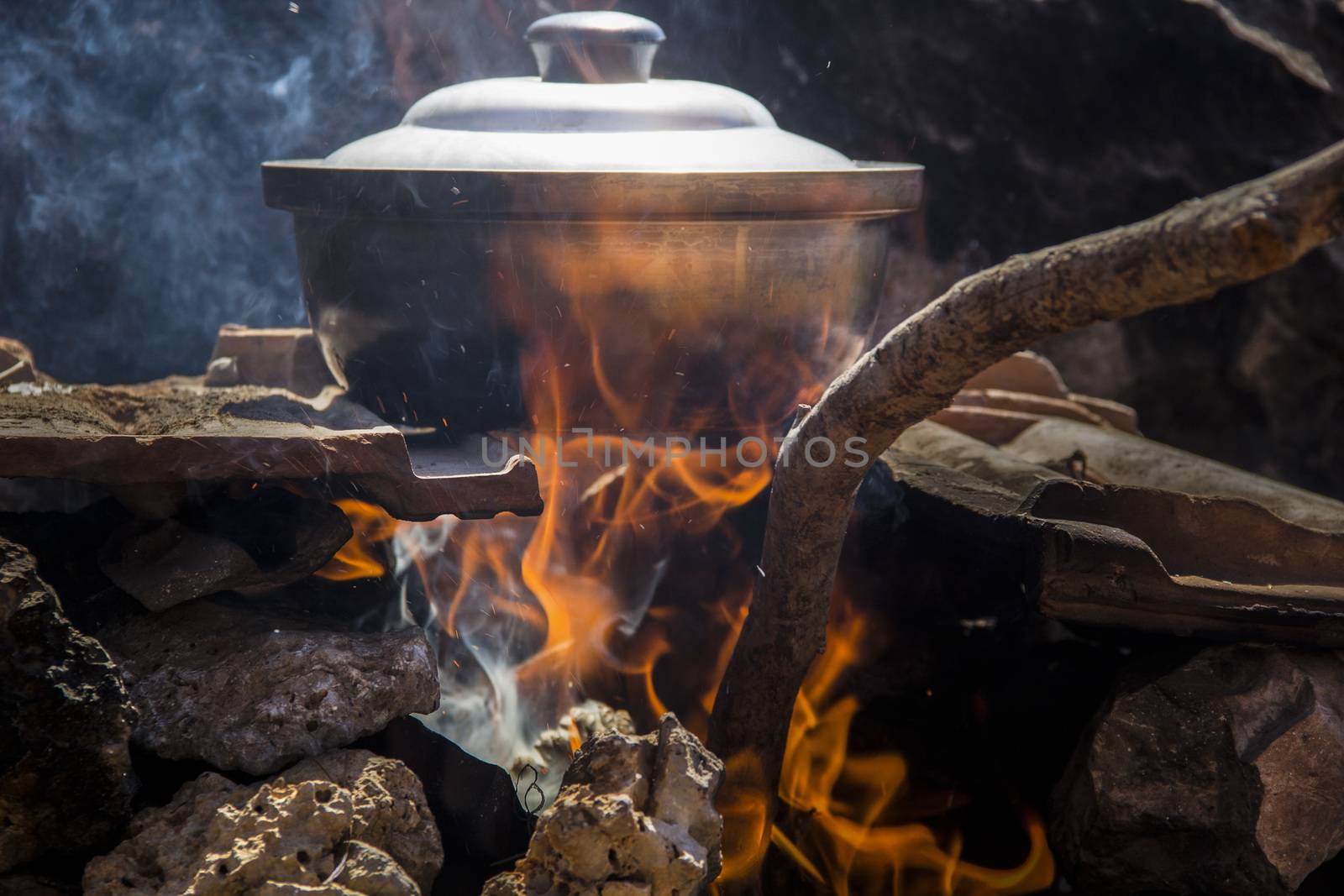 pot of fish soup being prepared on the fire, a warm quiet evening