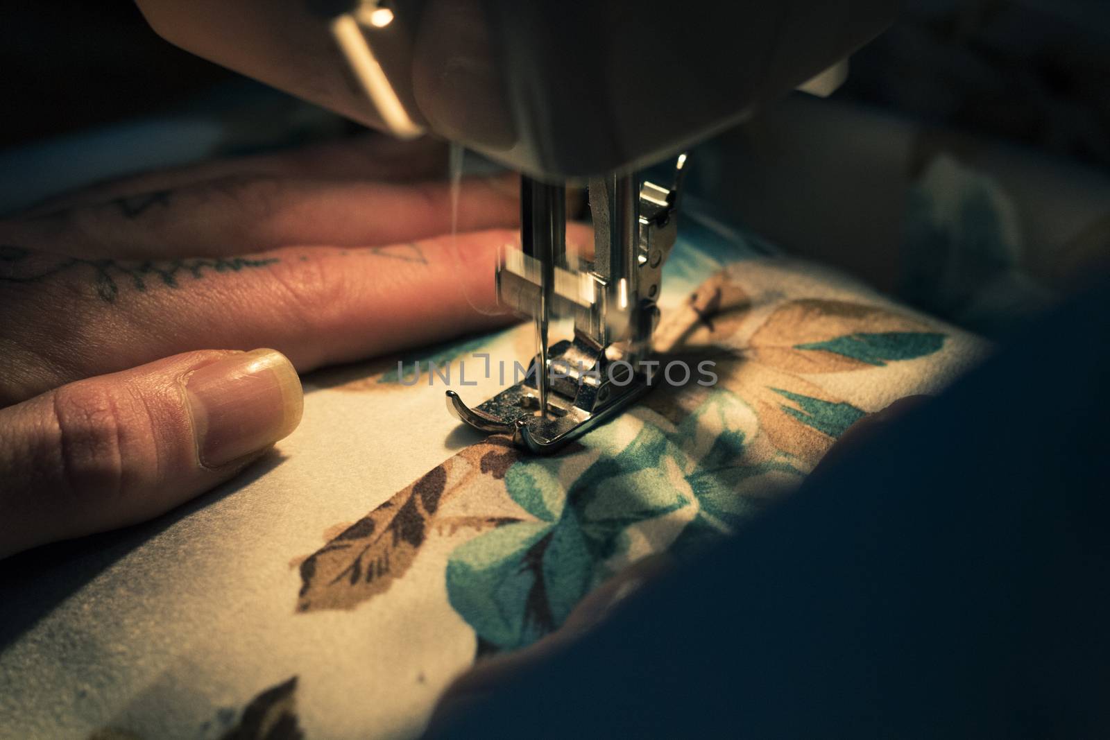 Tailor at Work on Sewing Machine with human hand