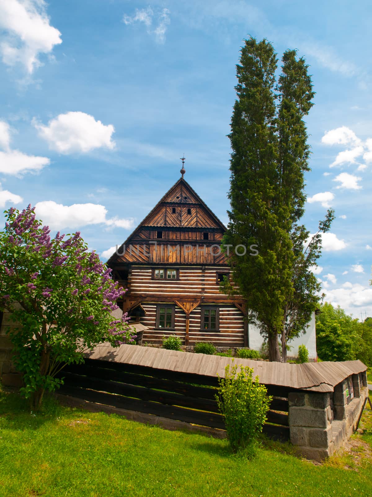 The Dlaskuv statek Farm - old timbered building typical for Jizera region, Dolanky Village near Turnov in Bohemian Paradise, Czech Republic, Europe. Sunny summer day shot with blue sky.