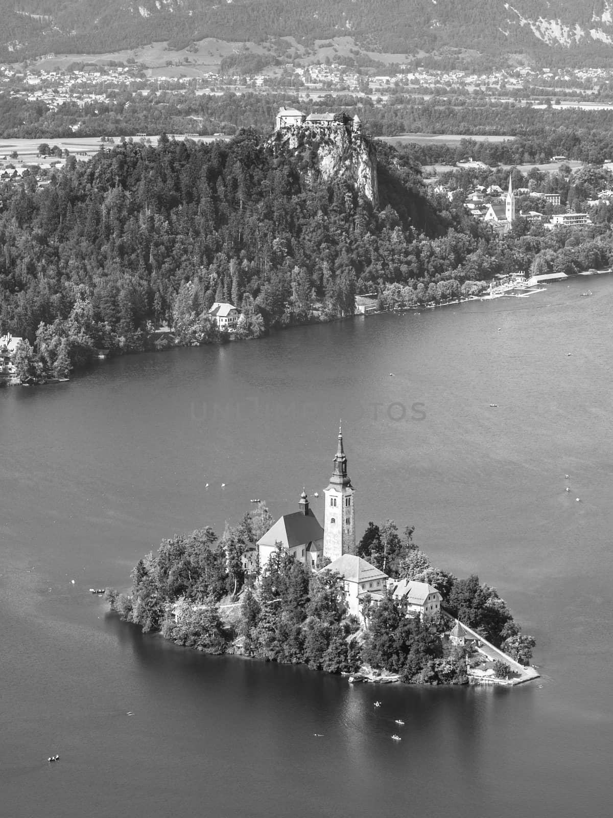 Lake Bled with St Mary's church on the island and Bled castle, Slovenia. Black and white image.