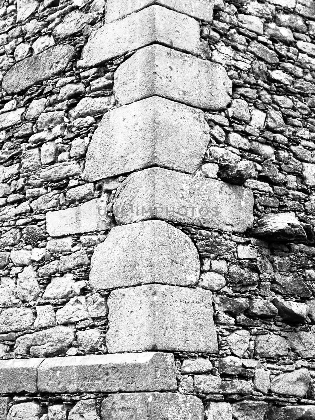 Construction detail of corner wall of old historical castle or ruin. Vintage architecture.