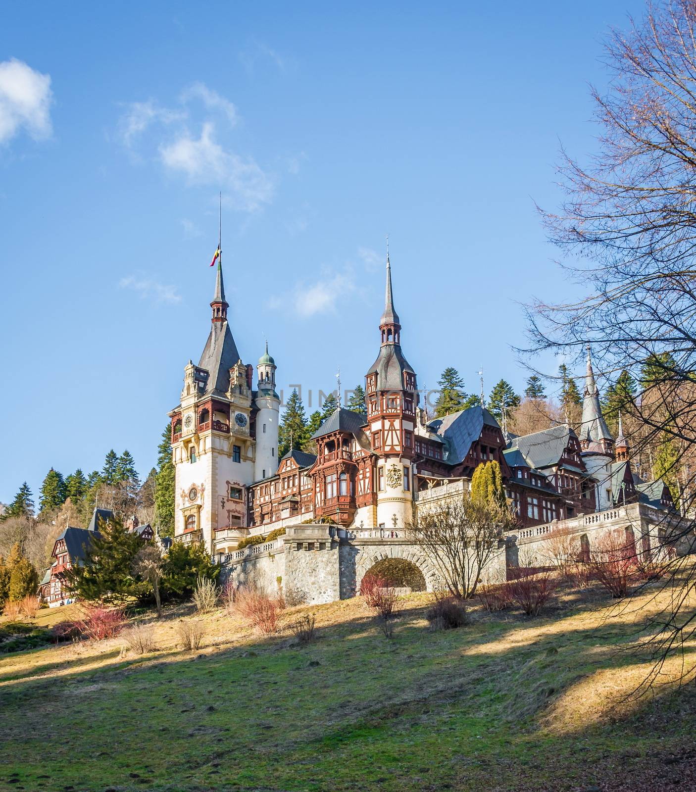 Peleș Castle near Sinaia and the Carpathian Mountains in a sunny day. Transylvania, Romania