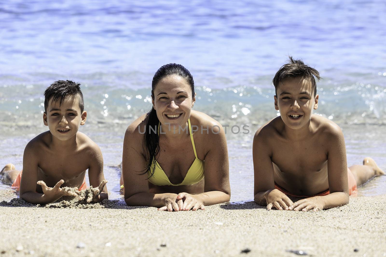 Family mother and her sons on the beach by nachrc2001