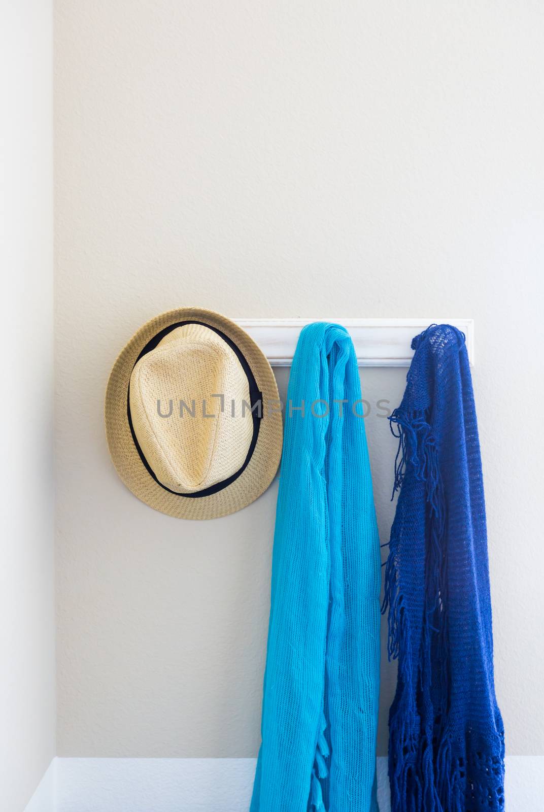 Wall in House with Hat and Scarfs Hanging on Coat Rack Hooks Abstract. by Feverpitched