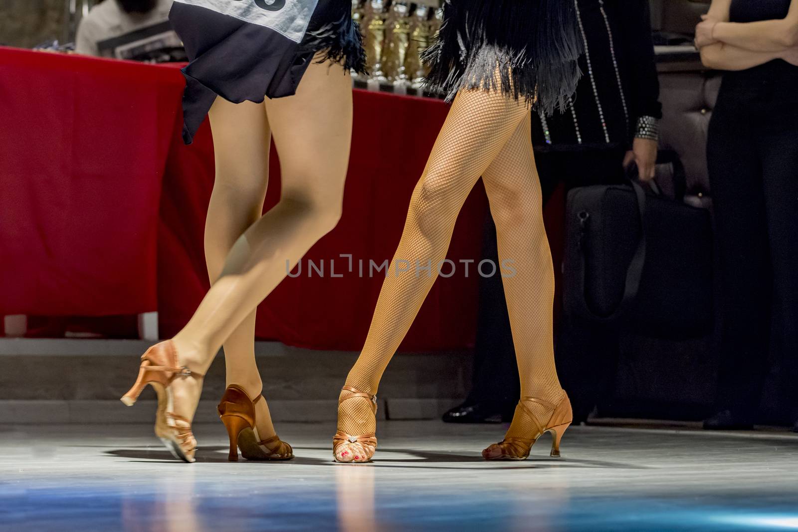 female legs of young girls who dance in competition