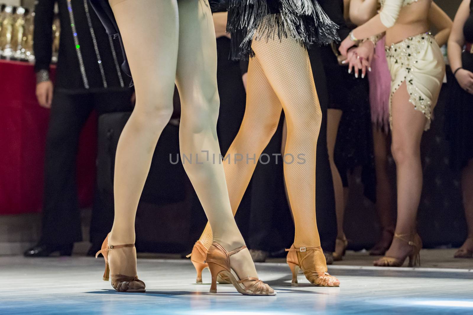 female legs of young girls who dance in competition