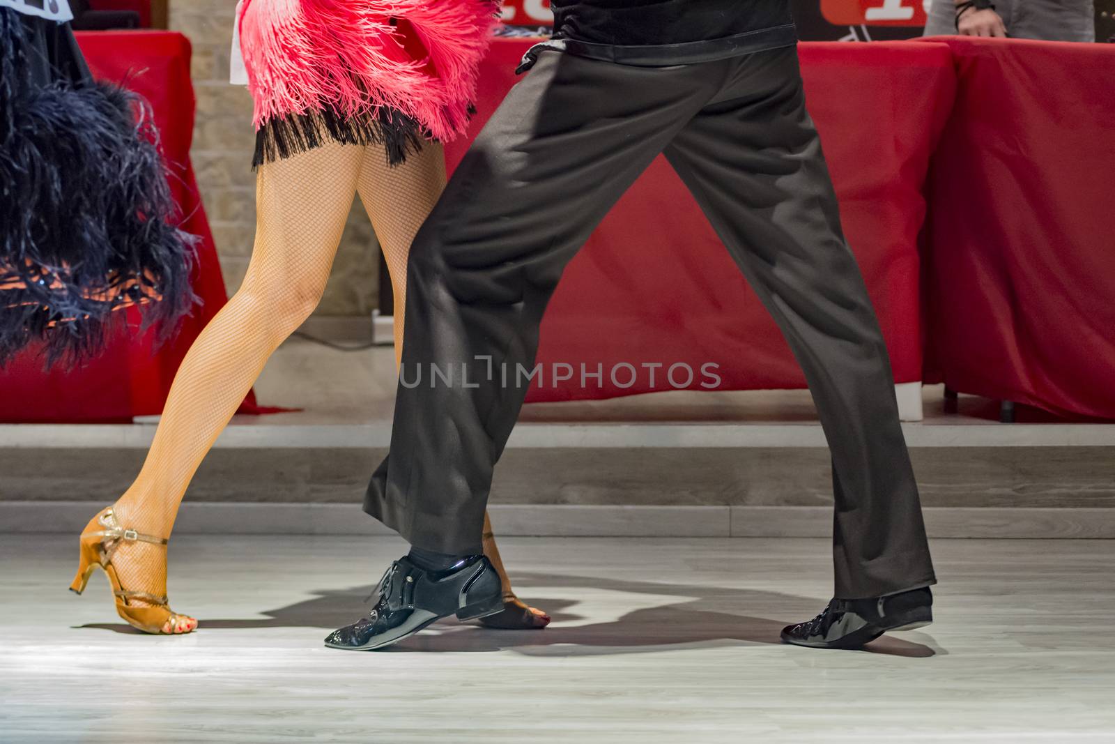 legs of a couple who dance in competition