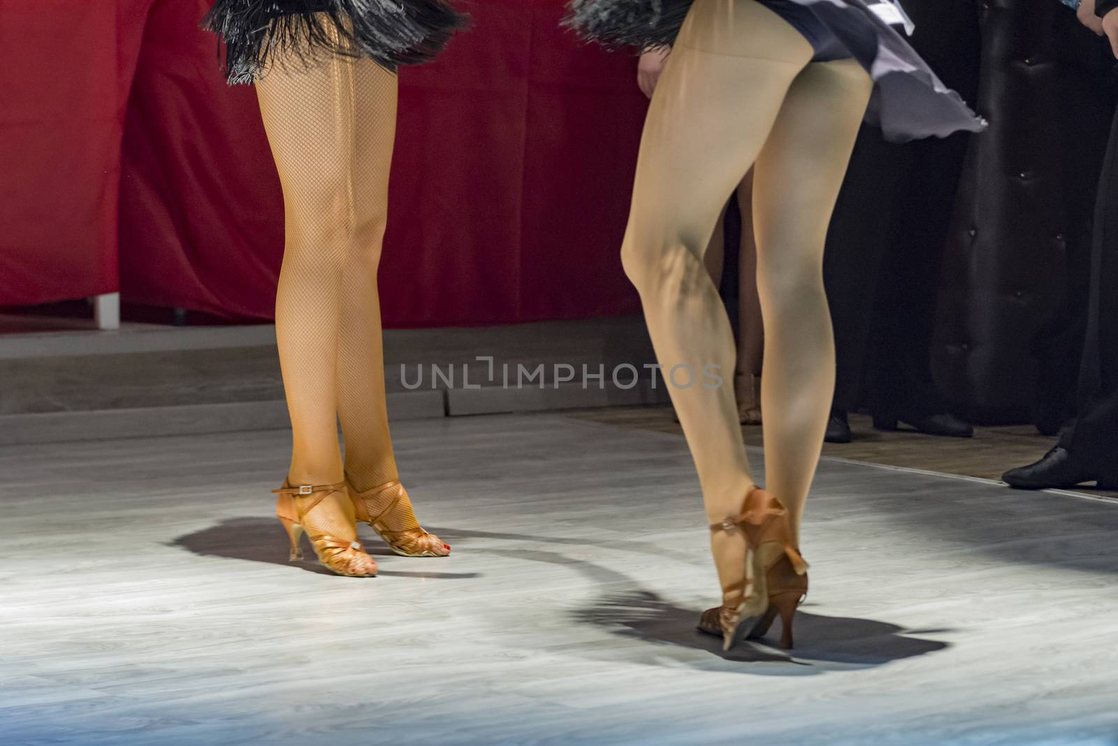 female legs of young girls who dance in competition