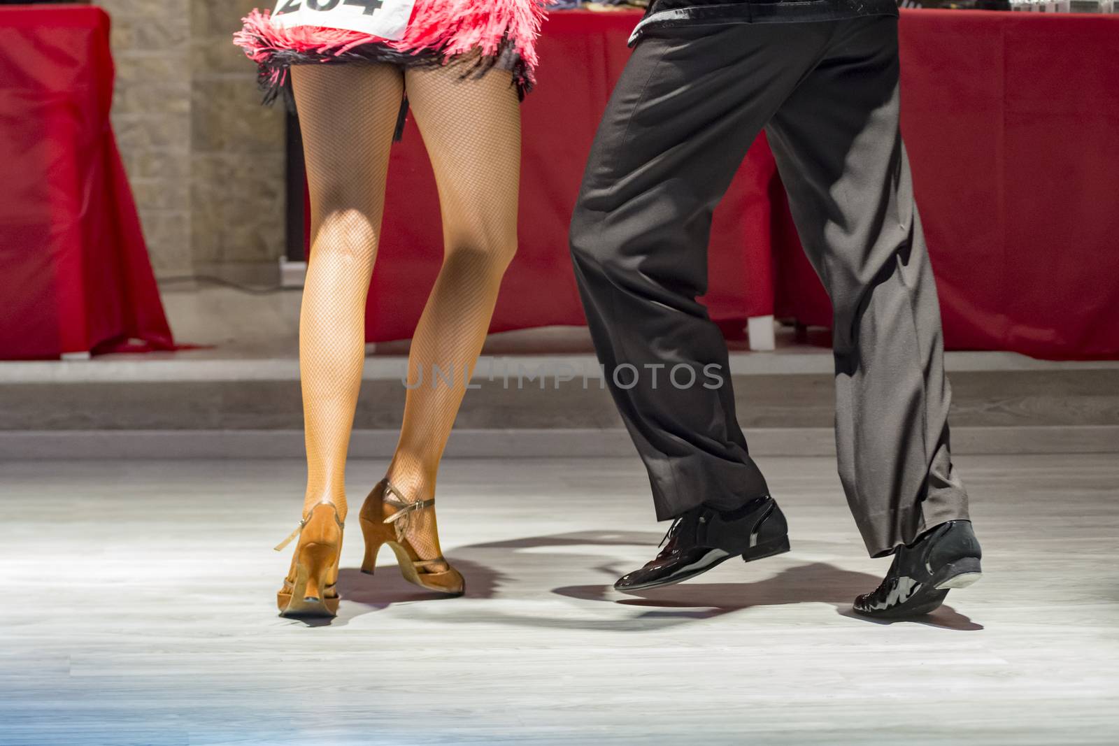 legs of a couple who dance in competition