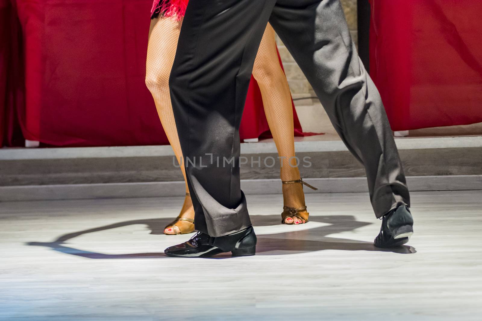 legs of a couple who dance in competition