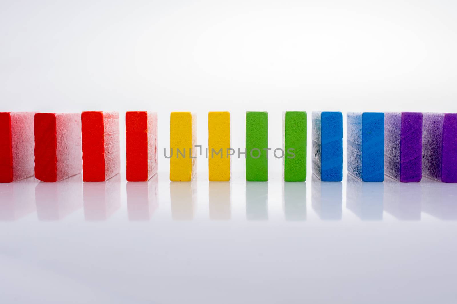 Colorful Domino Blocks in a line on a white background