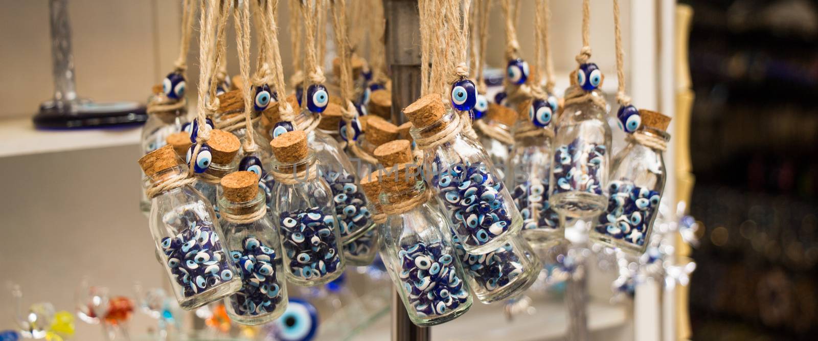 Little glass bottle filled with blue evil eye beads  by berkay