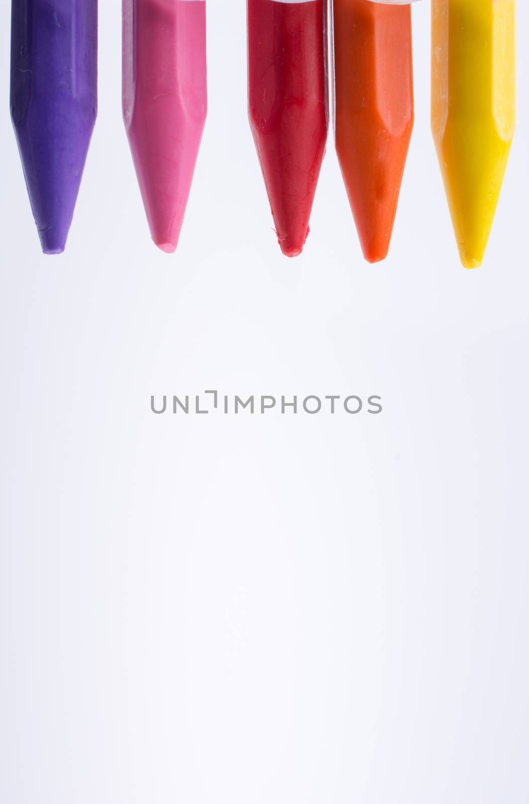 Crayons of various color on white background