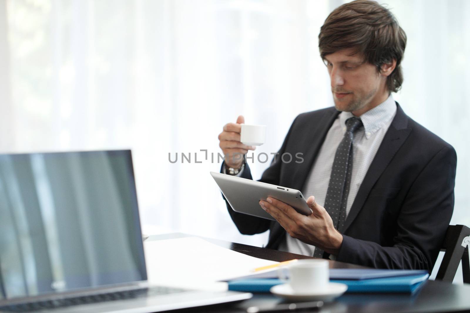 Business man with tablet computer by ALotOfPeople