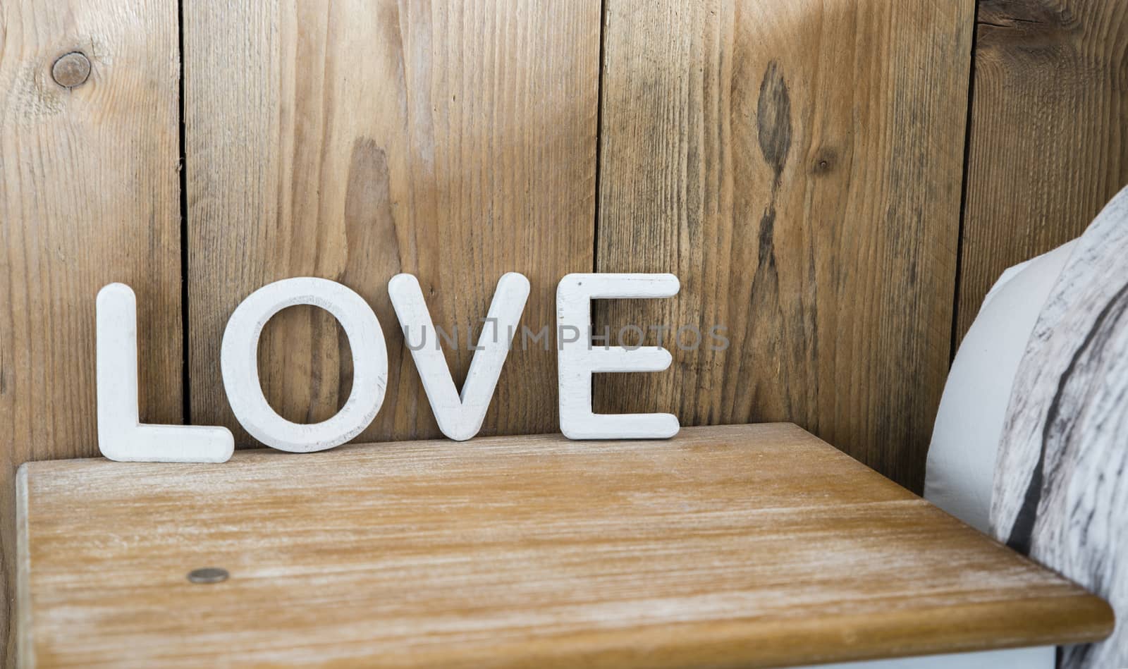 wooden love letters on bedside table by compuinfoto