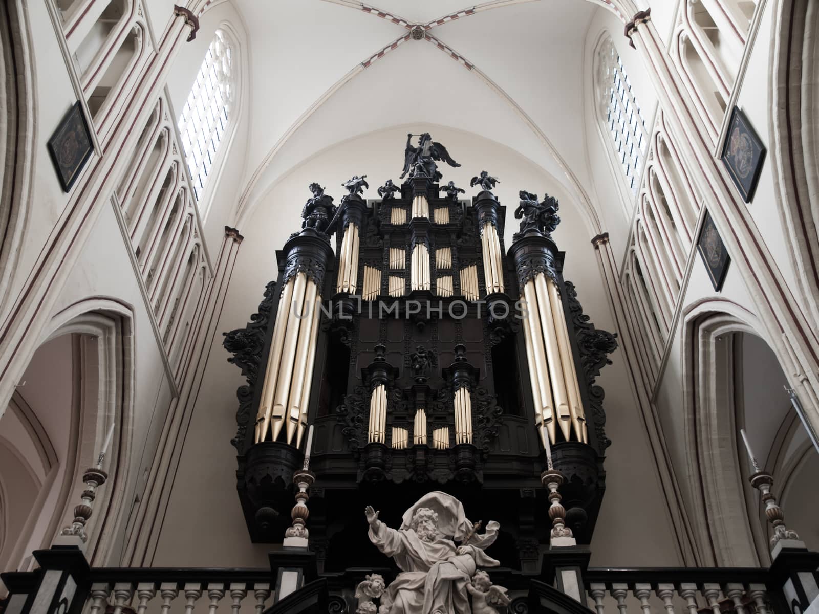 Black organ pipes in old white catholic church