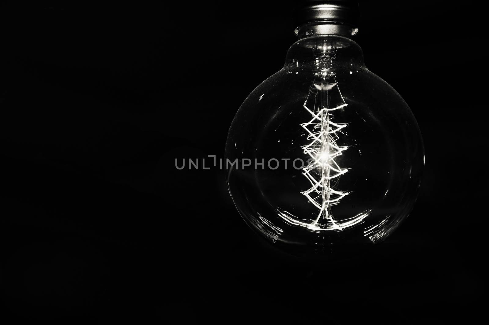 white electric light or bulb on a black background. a photo