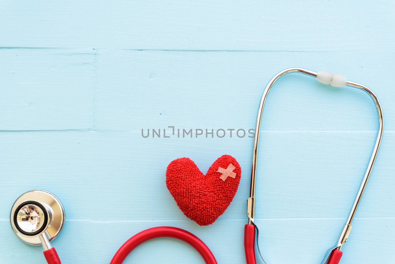 World health day, Healthcare and medical concept. Red heart with Stethoscope, notepad or notebook, thermometer and yellow Pill on Pastel white and blue wooden table background texture.