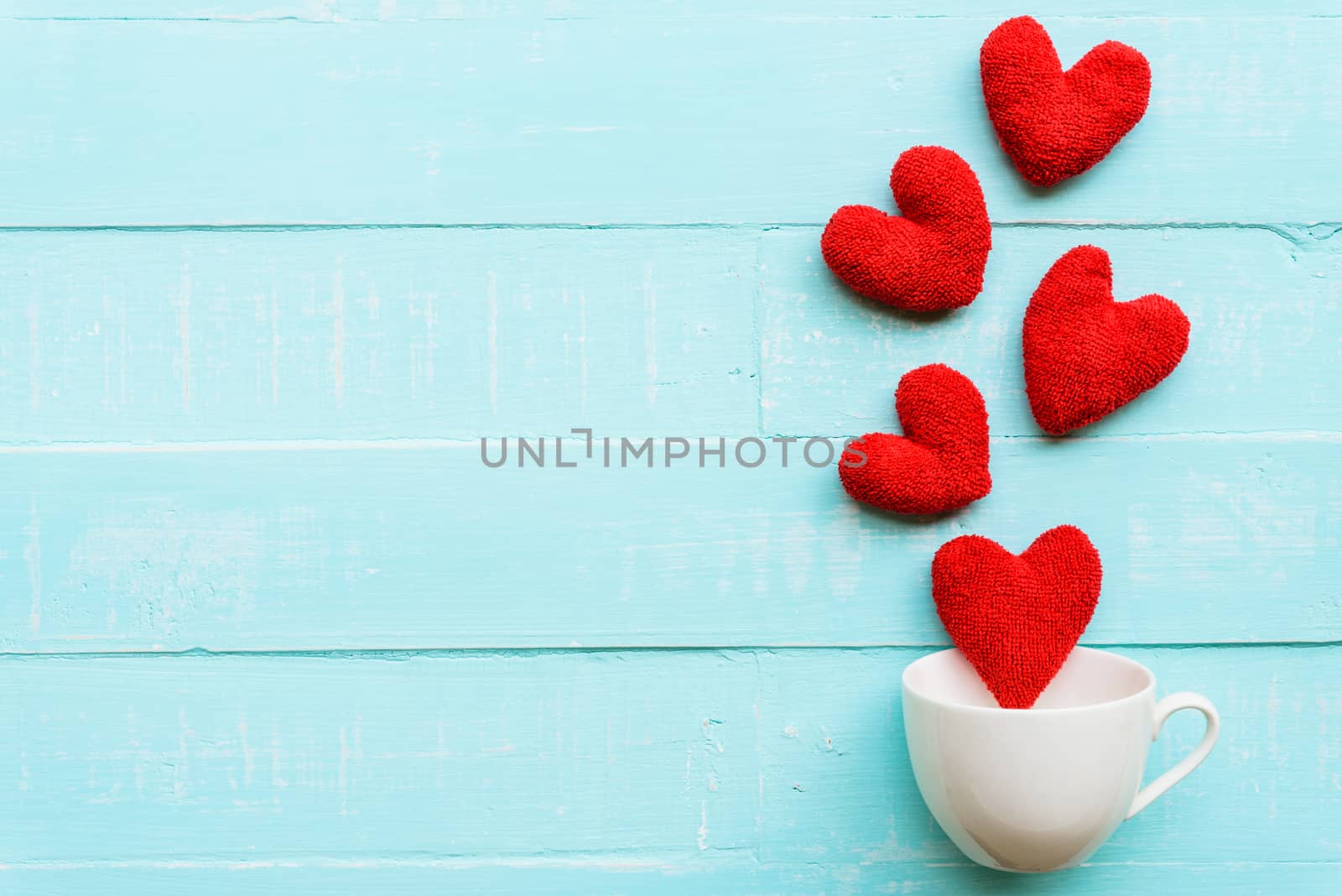 Top view  of handmade pink and red heart on blue and white color by spukkato