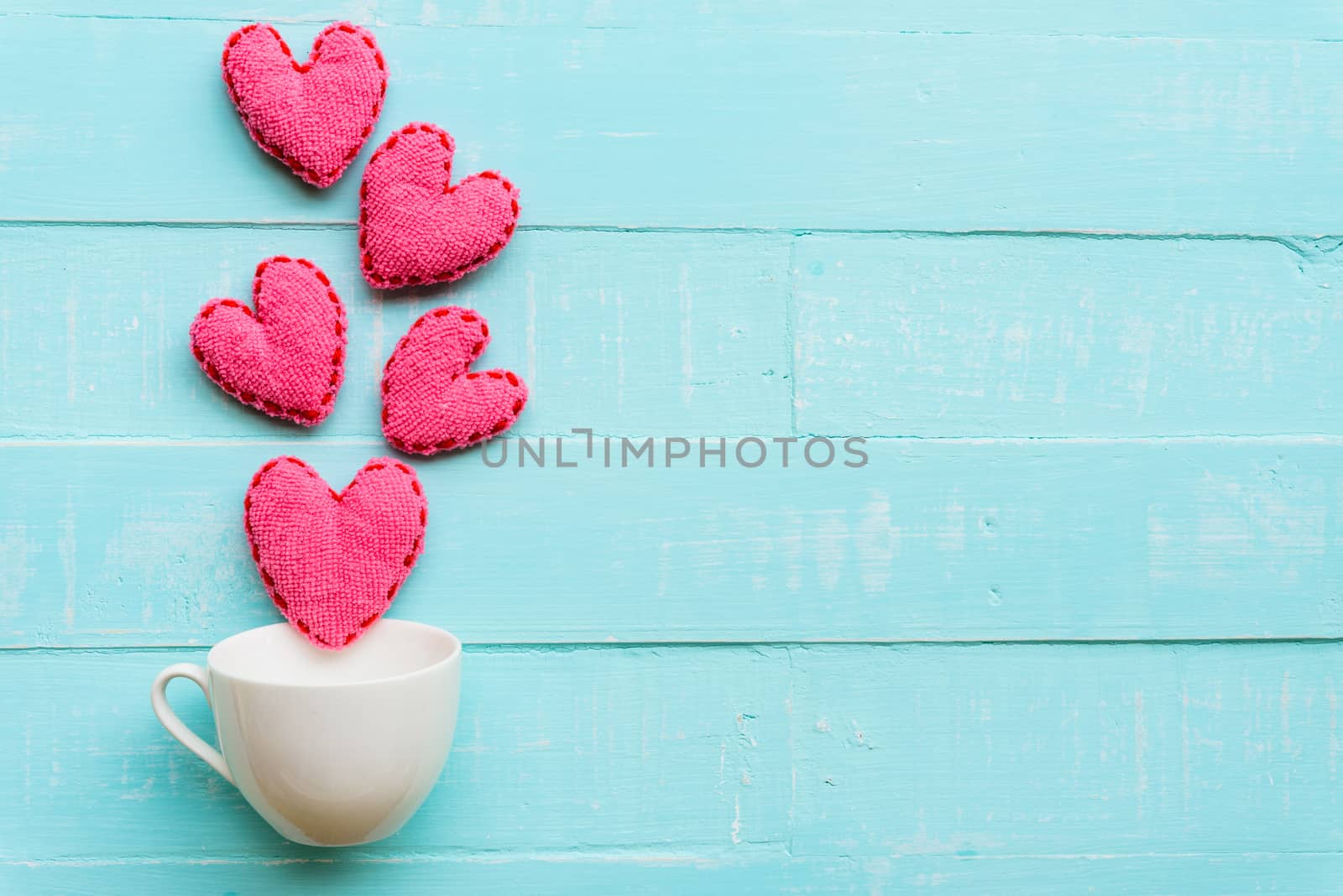 Top view  of handmade pink and red heart on blue and white color wooden background with pastel vintage style. Broken hearted, Love, Wedding and Valentines day concept.