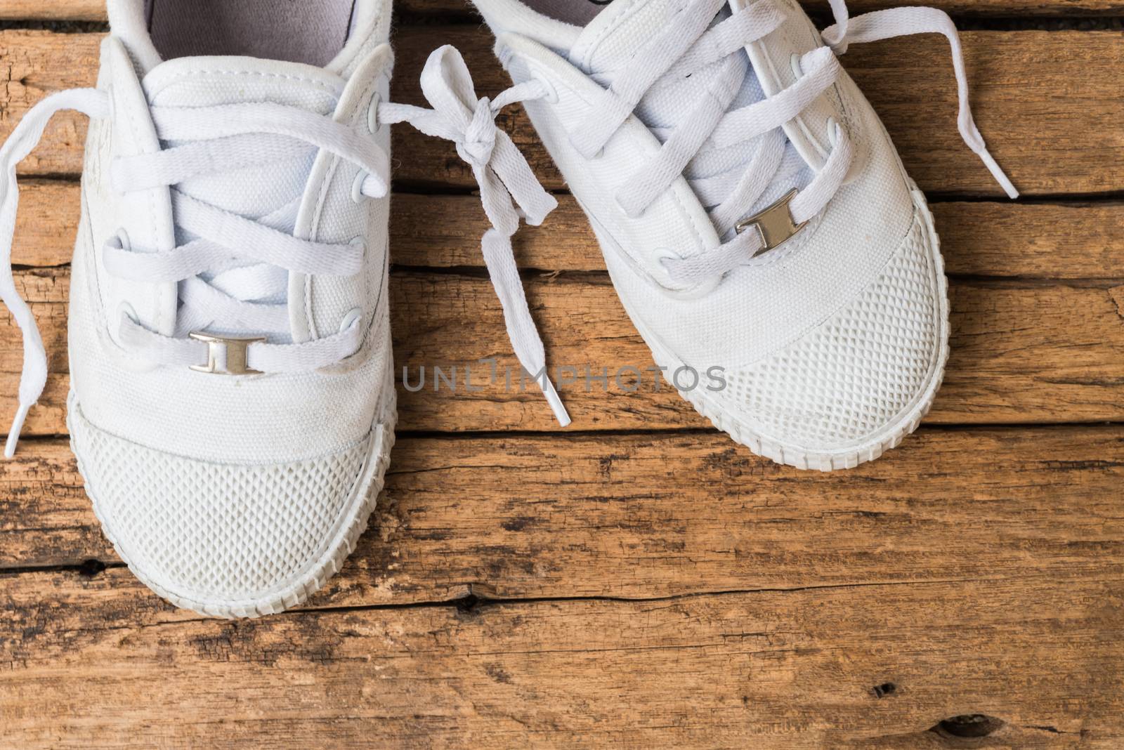 April fool's day concept. shoelaces tied together on wooden background.