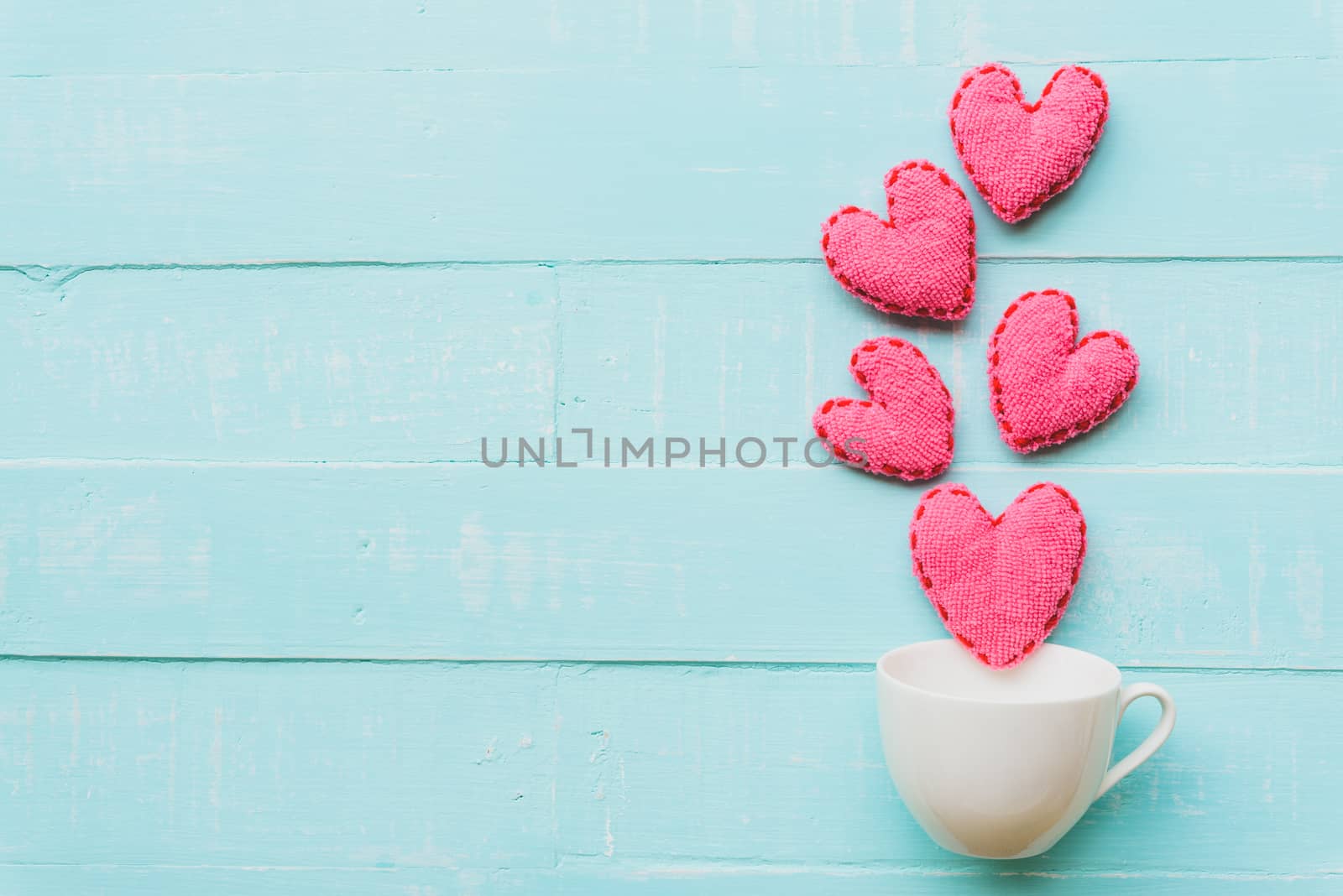 Top view  of handmade pink and red heart on blue and white color wooden background with pastel vintage style. Broken hearted, Love, Wedding and Valentines day concept.