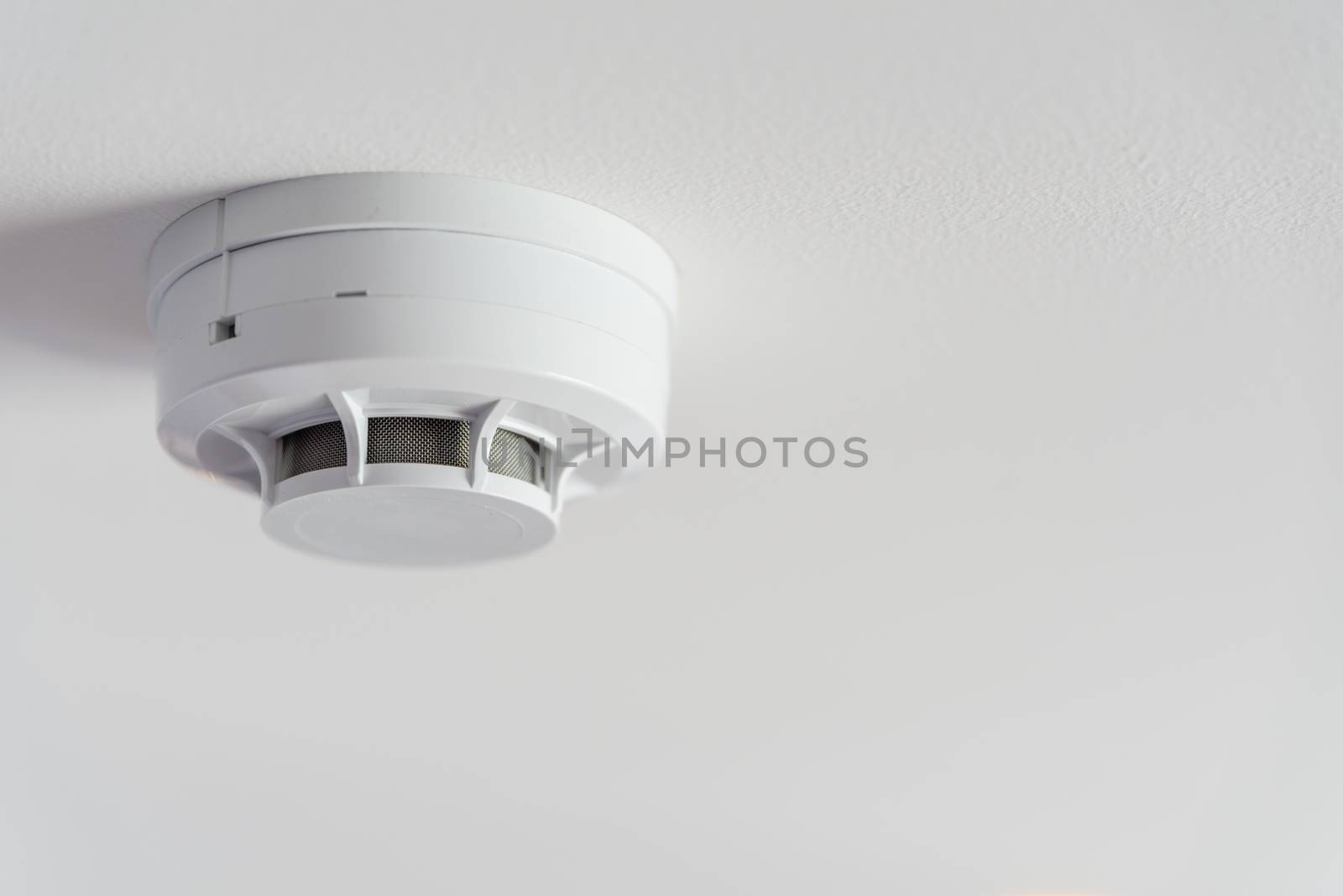 Close up smoke detector on a ceiling. by spukkato