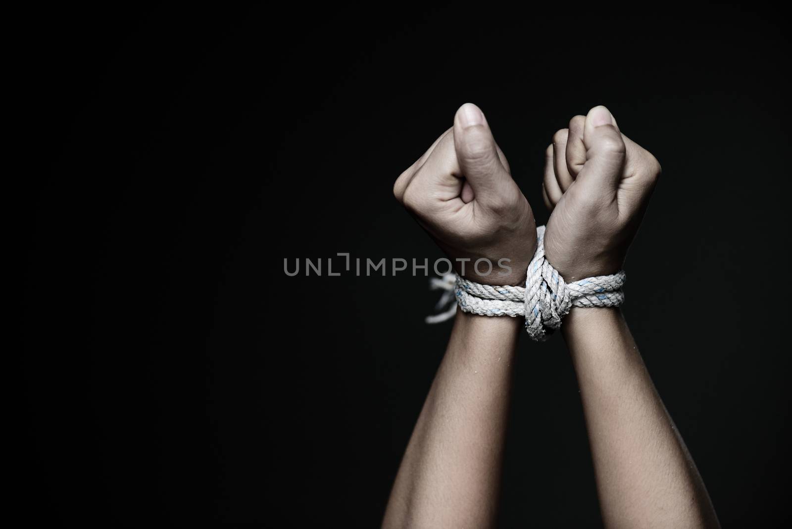 Closeup woman hands were tied with a rope. Violence, Terrified,  by spukkato