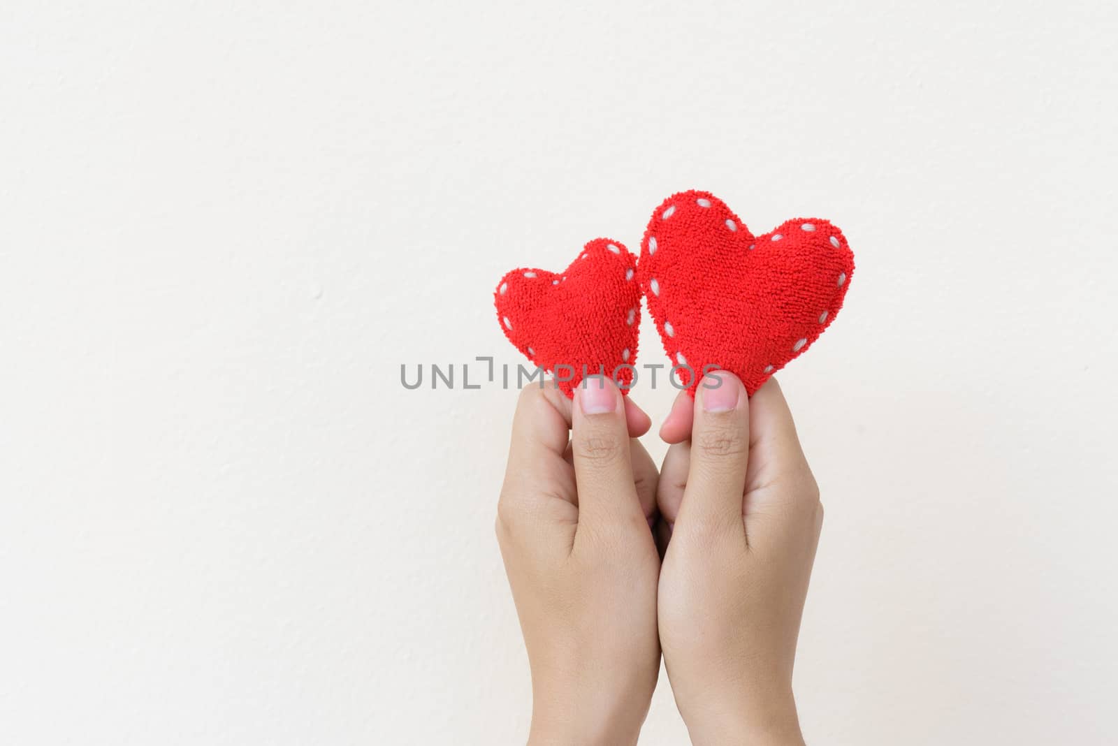 Two hand holding two red heart on white background. Happy, Love, by spukkato