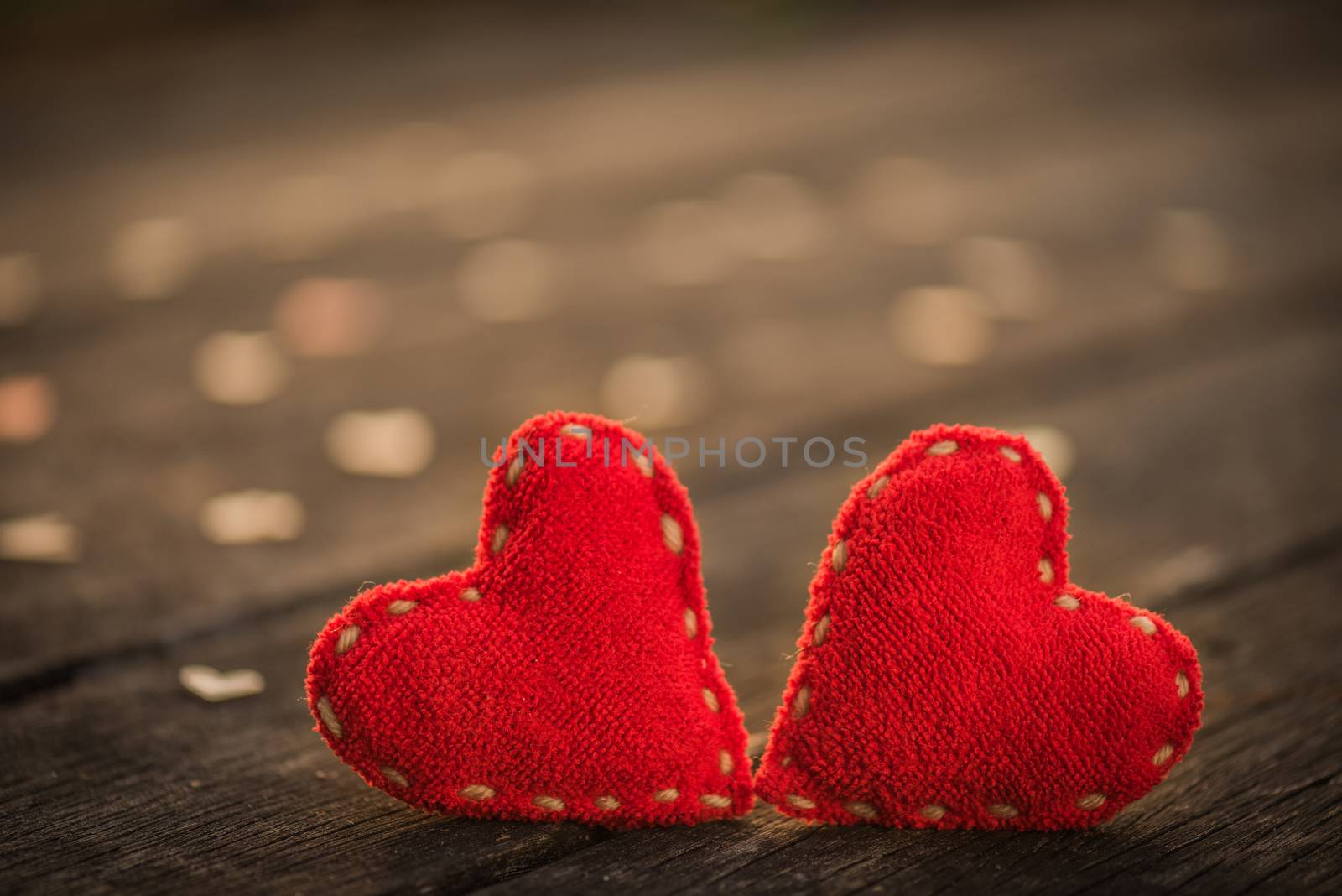 Two red heart with a lot of wooden hearts on wooden background w by spukkato