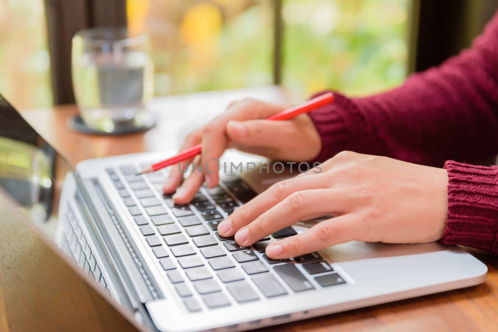 Soft focus Closeup woman hand working on her laptop. Social networking technology concept.