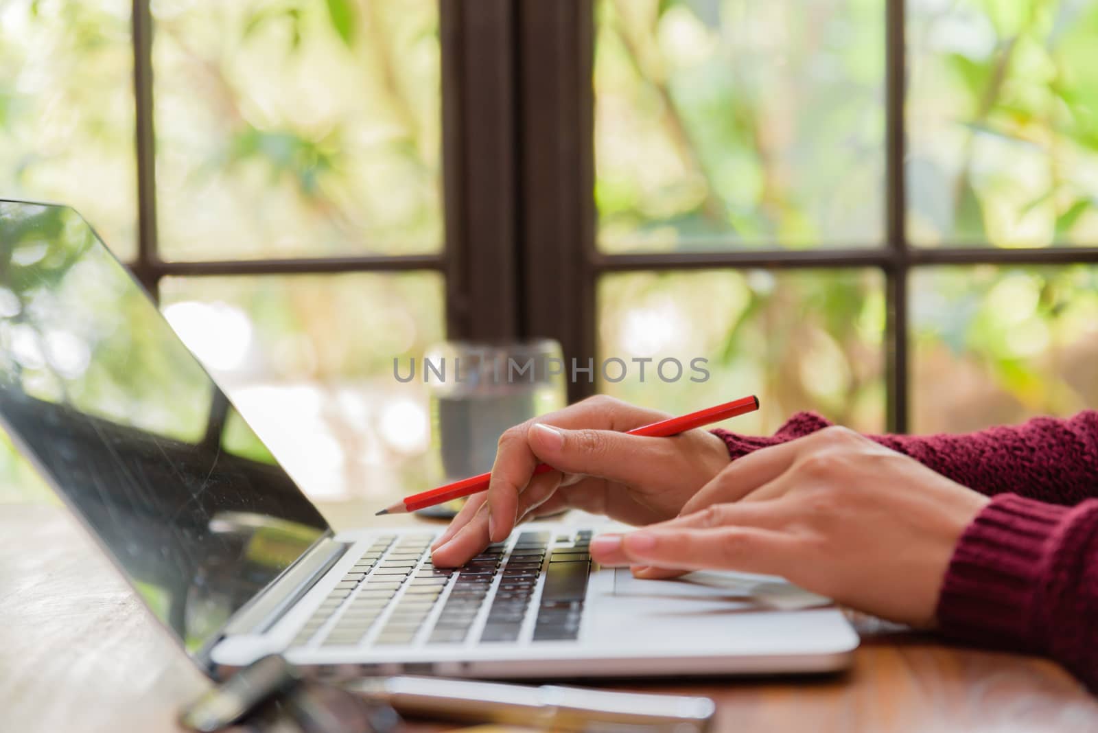 Soft focus Closeup woman hand working on her laptop. Social networking technology concept.