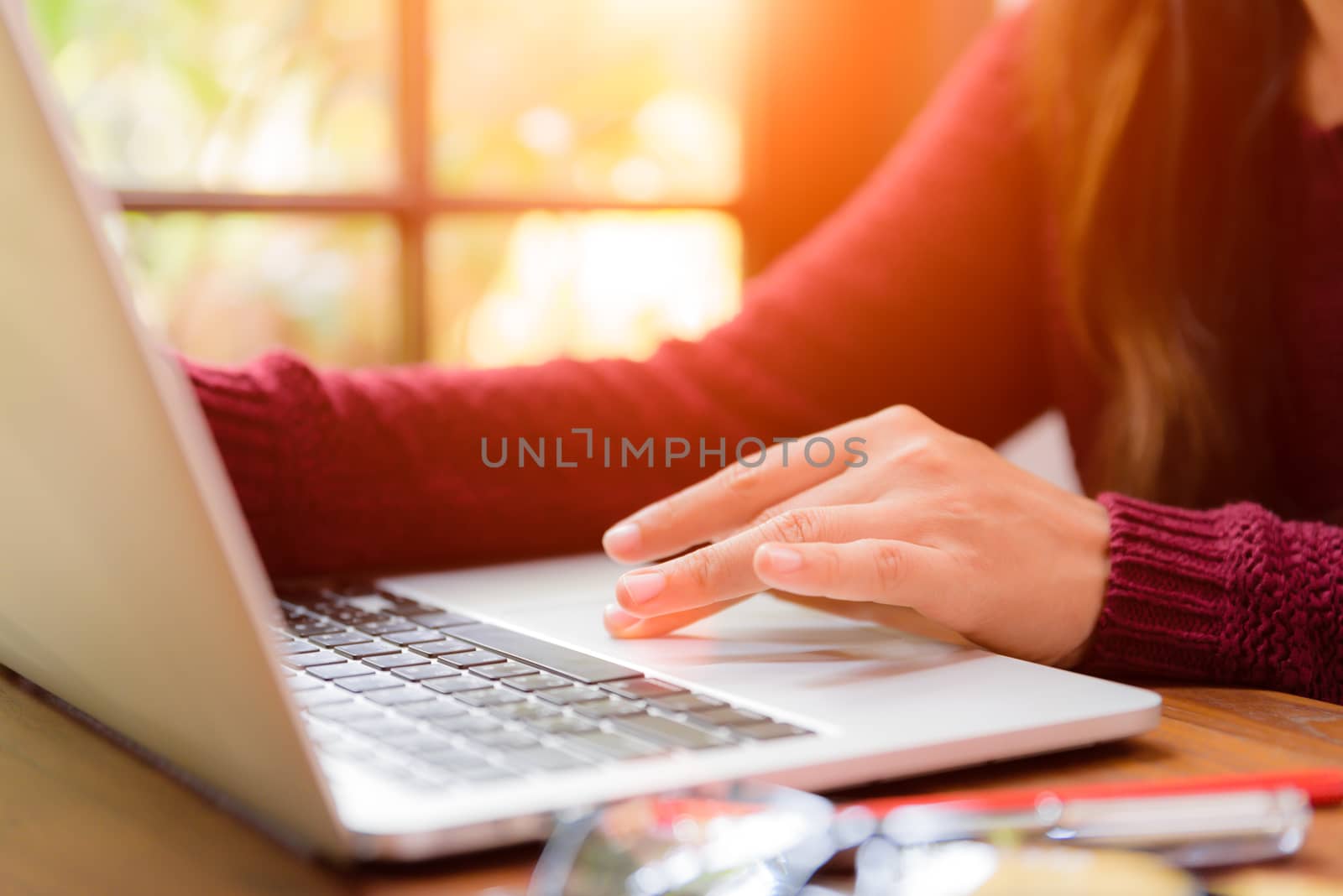 Soft focus Closeup woman hand working on her laptop. Social networking technology concept.