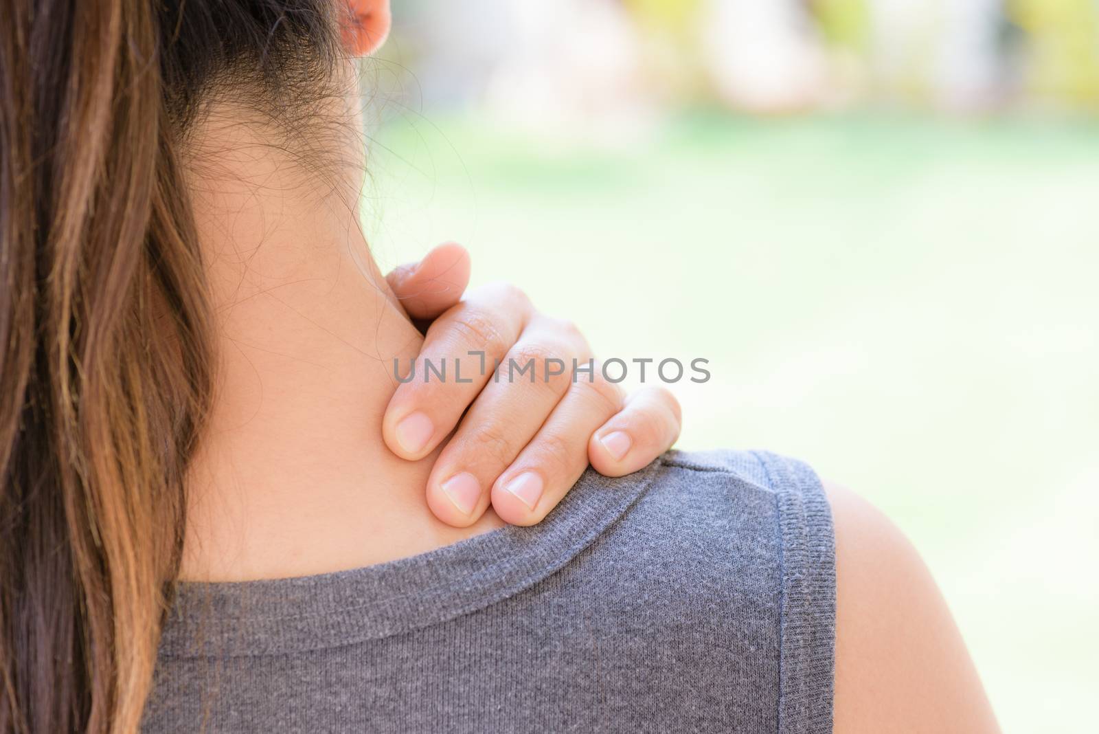 Closeup woman neck and shoulder pain and injury. Health care and by spukkato