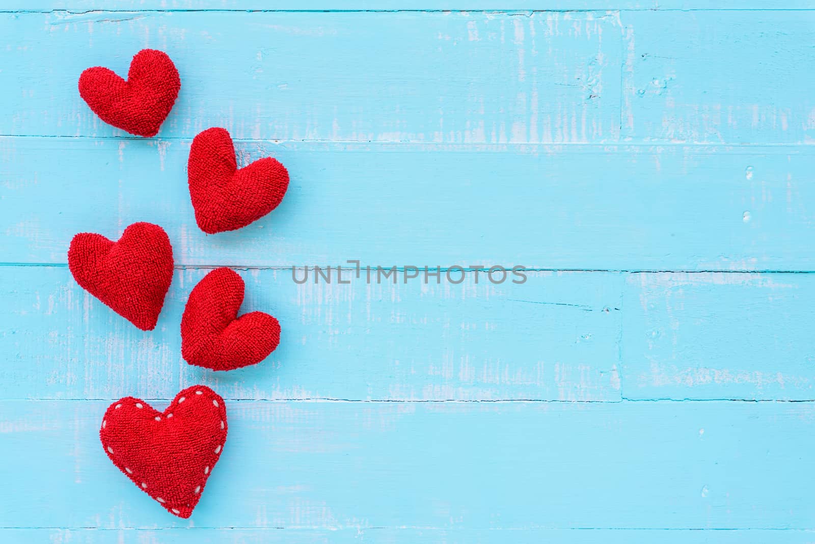 Top view  of handmade pink and red heart on blue and white color by spukkato