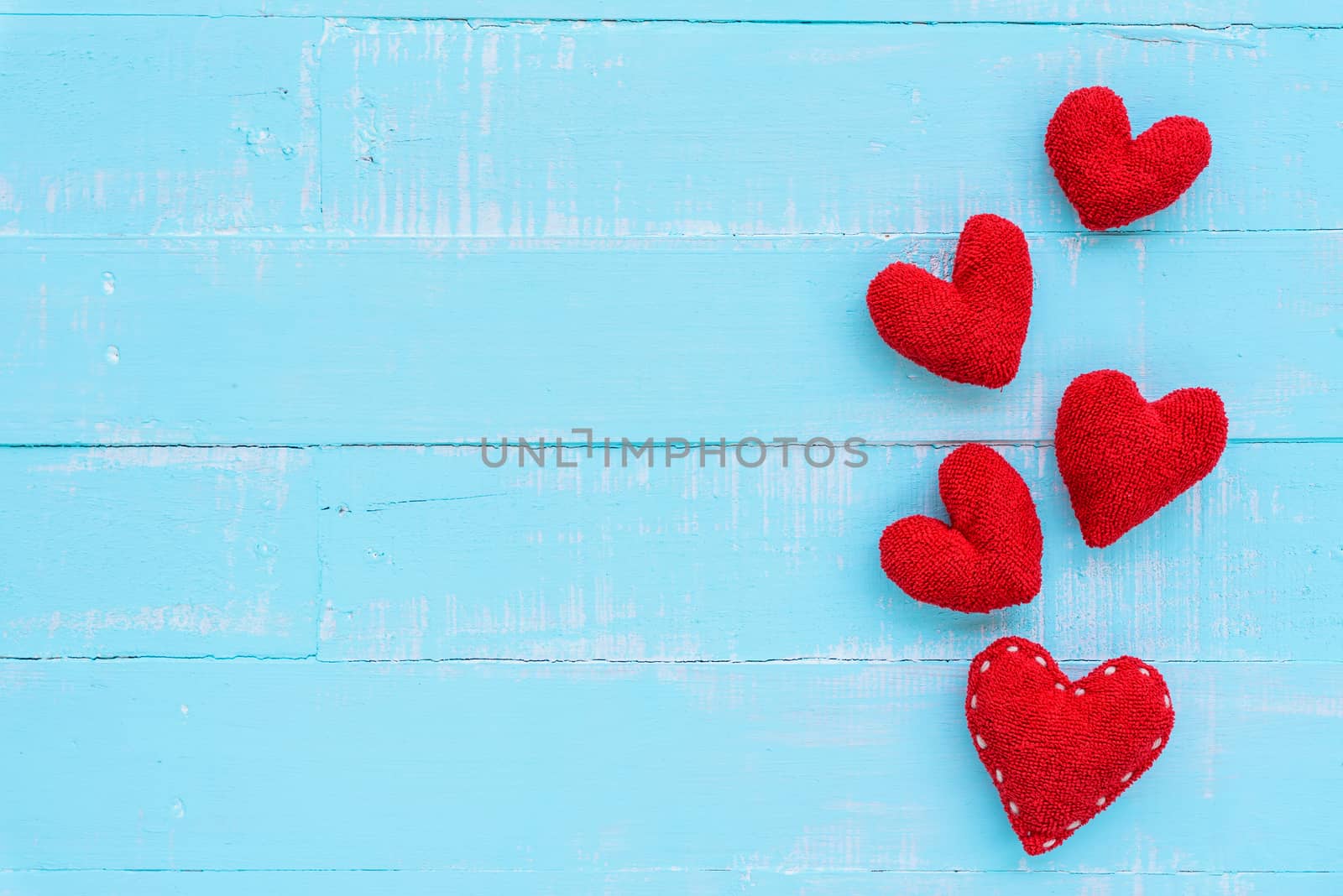 Top view  of handmade pink and red heart on blue and white color wooden background with pastel vintage style. Broken hearted, Love, Wedding and Valentines day concept.
