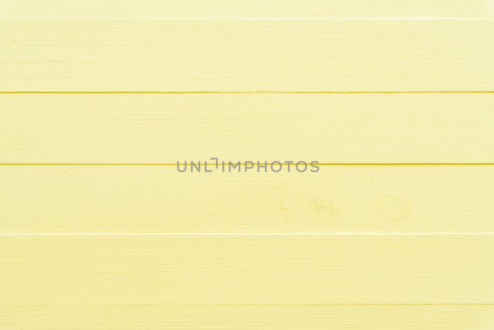 Pastel bright yellow wooden table background texture. by spukkato