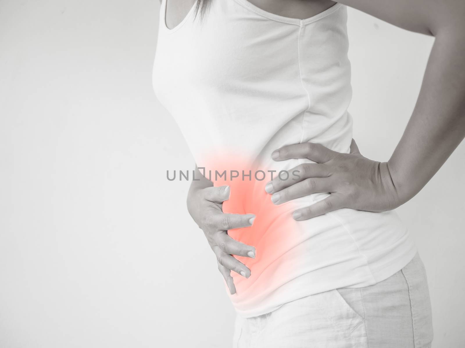 Woman having a stomachache, or menstruation pain with white background. Health care and medical concept.