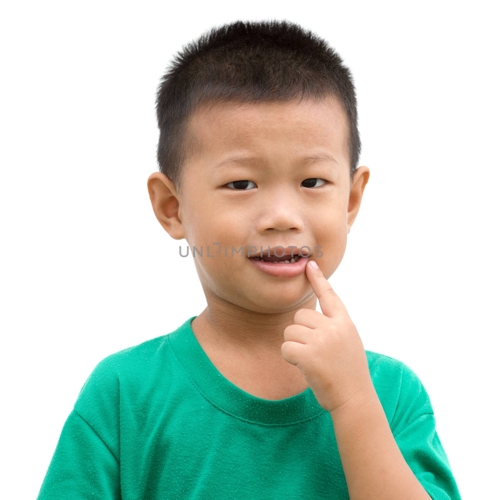 Happy Asian child pointing his mouth and smiling. Portrait of young boy showing body parts isolated on white background.