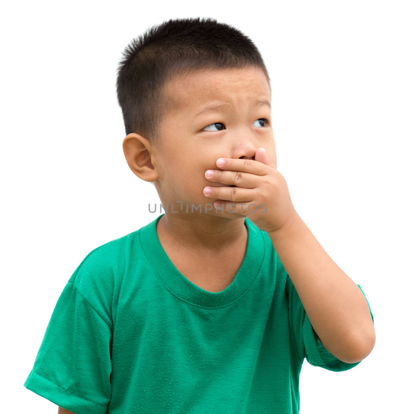 Asian child covering his mouth and looking to side. Portrait of young boy isolated on white background.