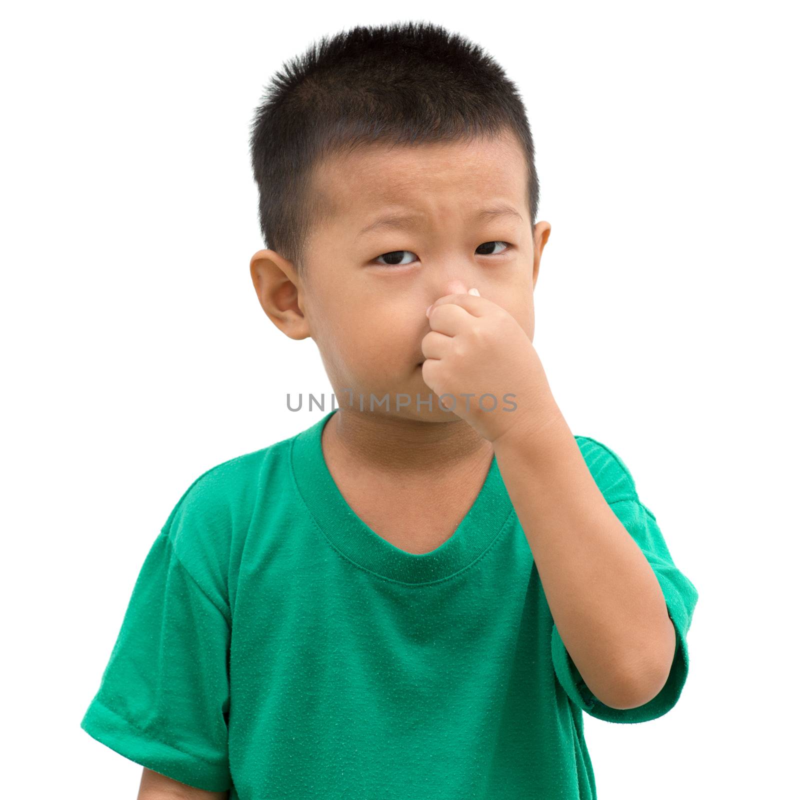 Asian child pinching his nose. Portrait of young boy isolated on white background.