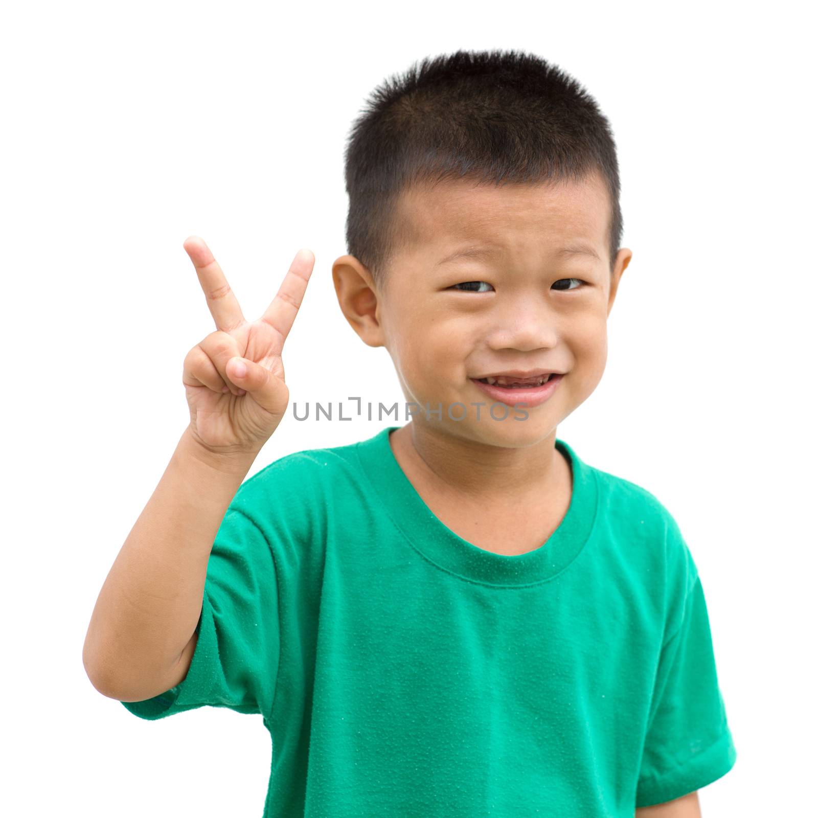 Asian child showing peace hand sign. Portrait of young boy isolated on white background.