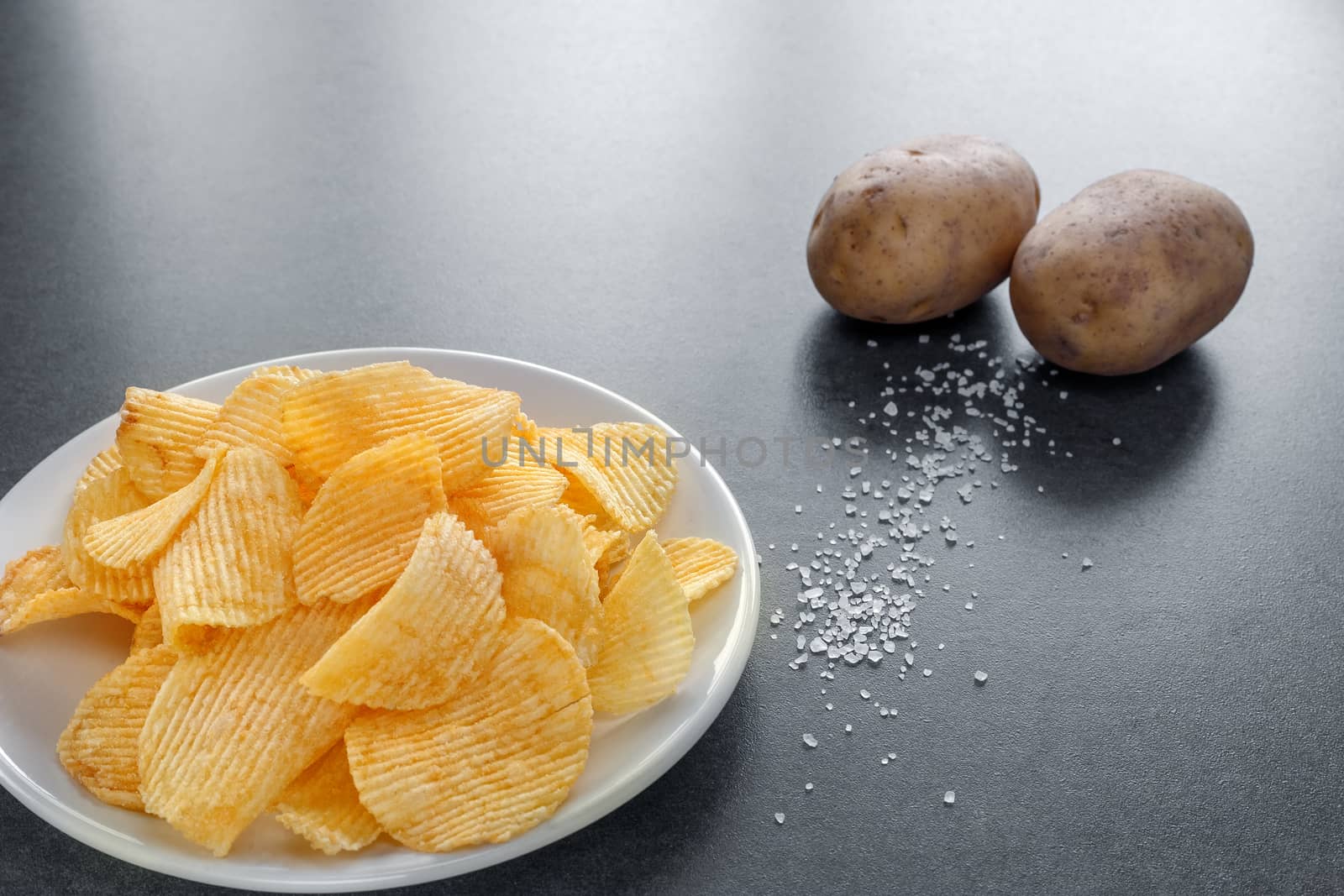 potato chips on a plate by ires007