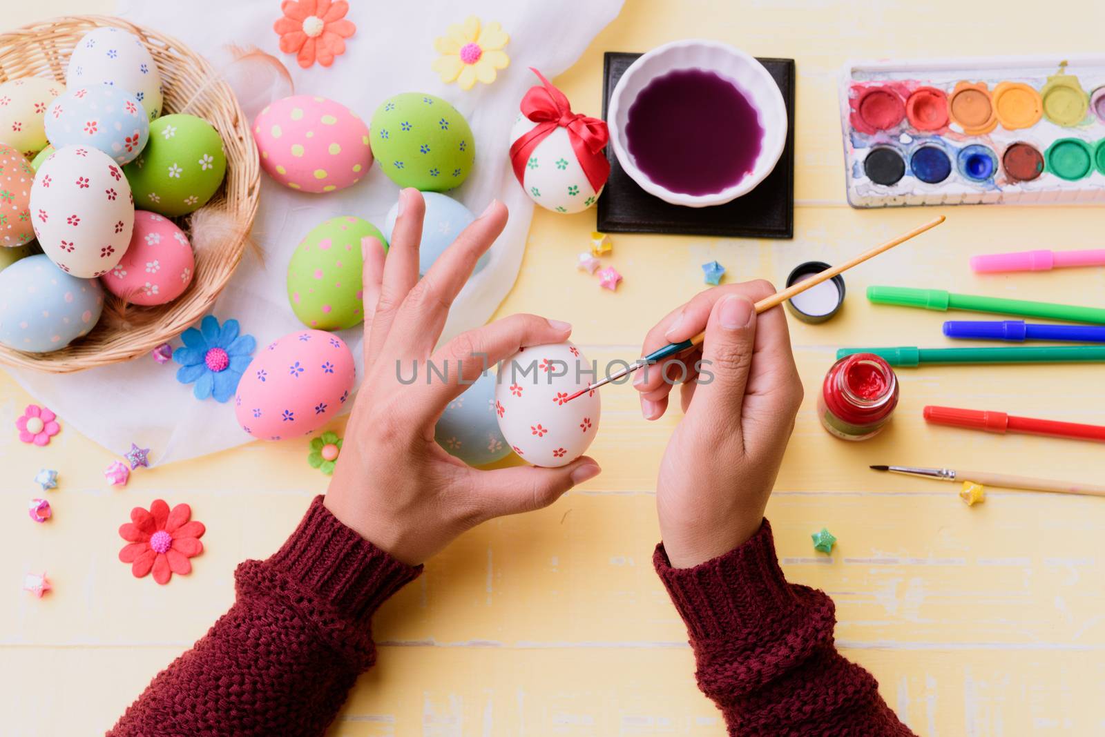 Happy easter! A woman hand painting Easter eggs. Happy family preparing for Easter.