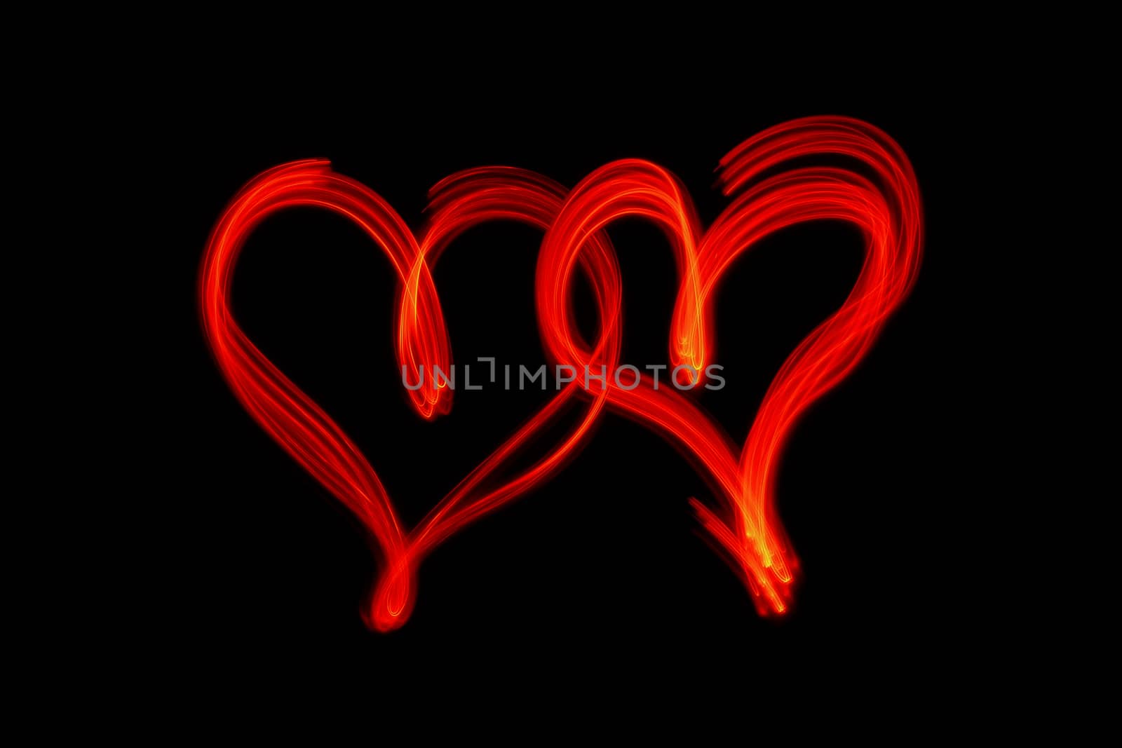 couple of red hearts on black background