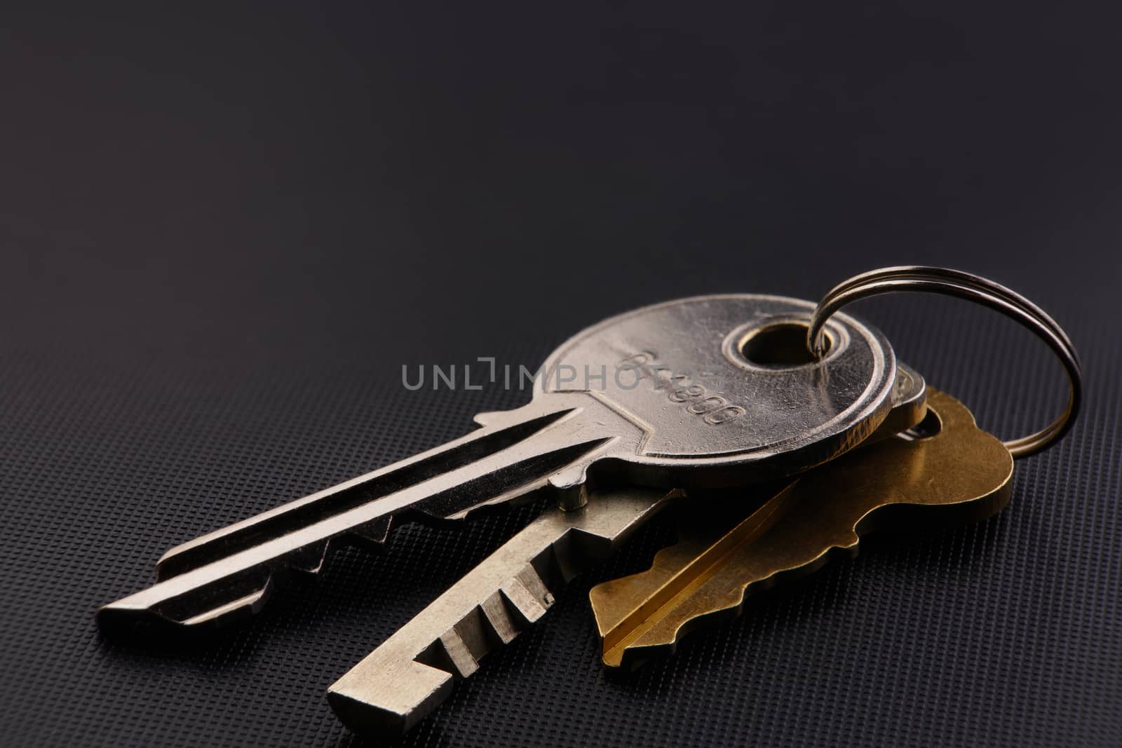 set of three keys on a black background