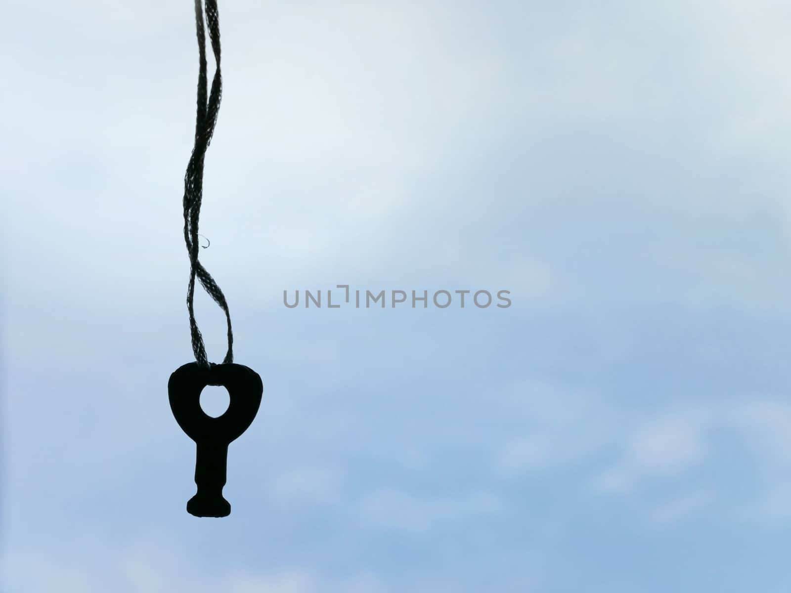 hanging key on the sky background