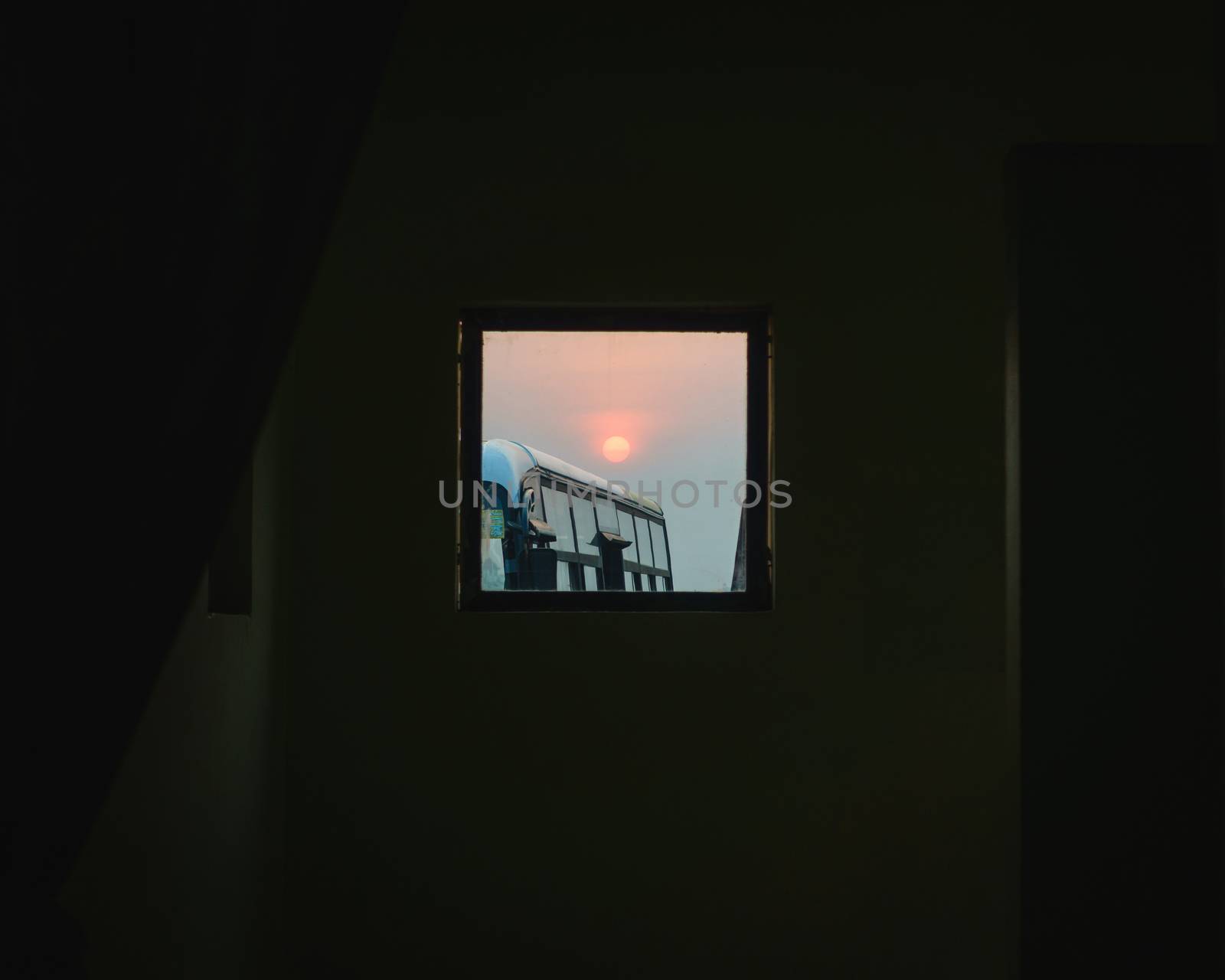 Sunrise seen through a small square window at Kathmandu airport. Lots of negative space.
