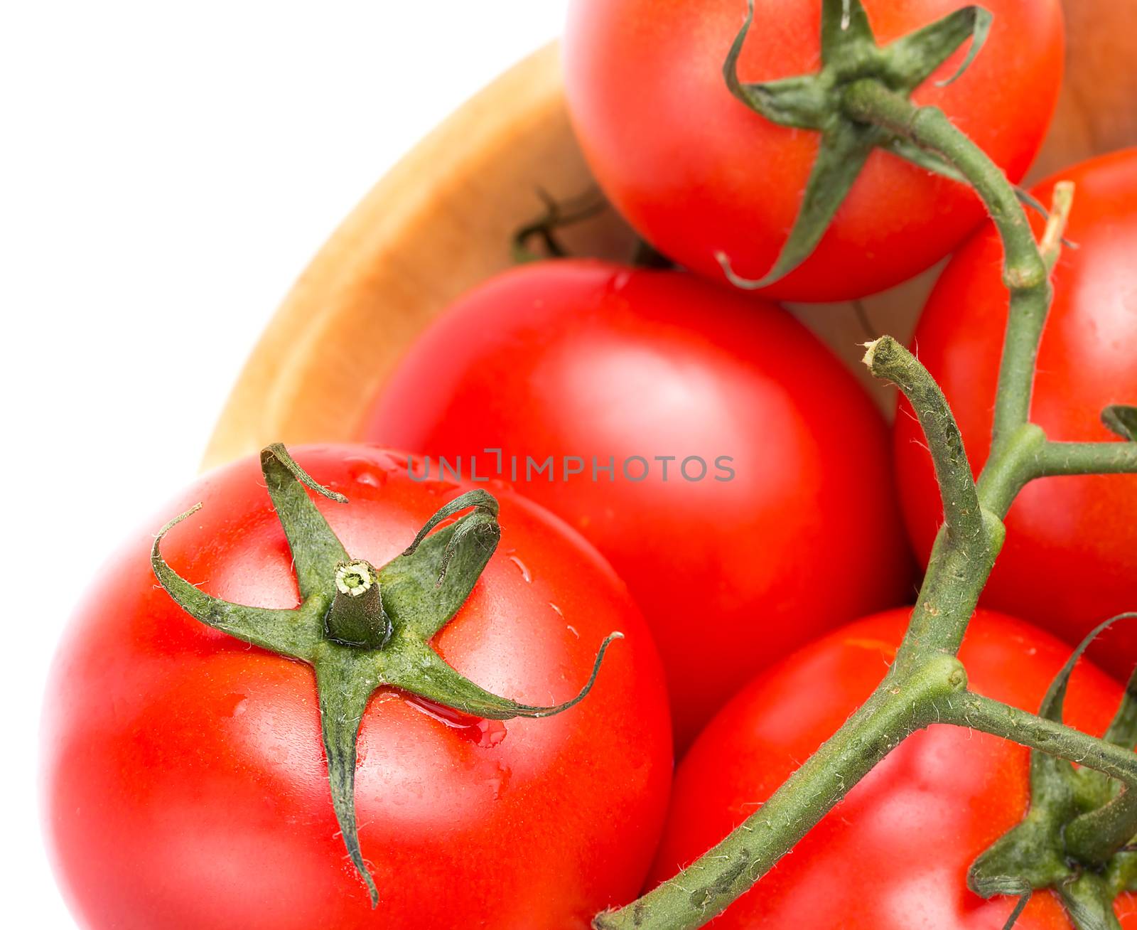 Closeup of fresh vine tomatoes in a bowl on the table  by stuartmiles